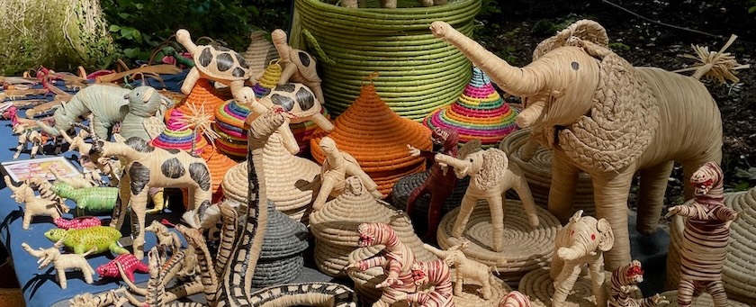 Animals made from straw and bast exhibited on a table