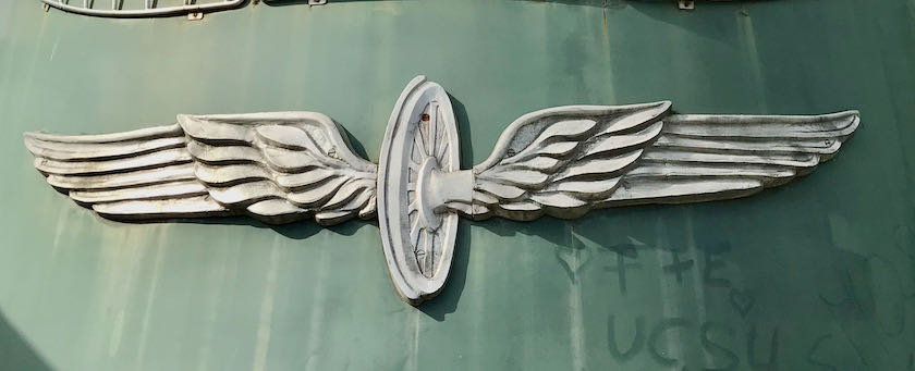 Emblem on front of a locomotive showing a winged wheel
