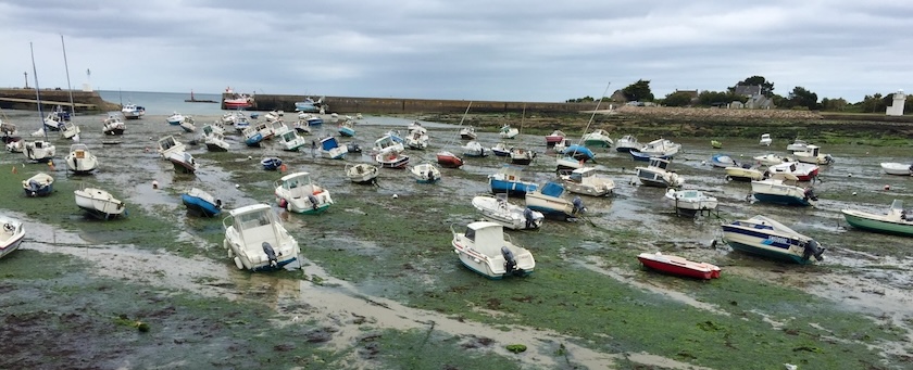 Boats lying on harbor ground at low tide