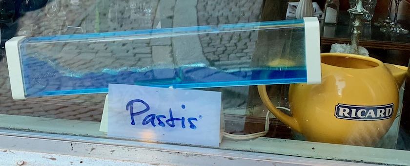 A wave machine and a pastis jug (seen in a shop window in Stockholm, Sweden)