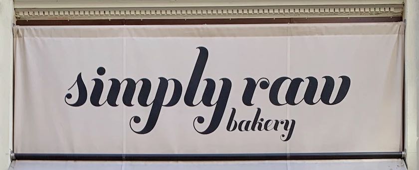 Shop sign saying "Simply raw bakery" (seen in Vienna)